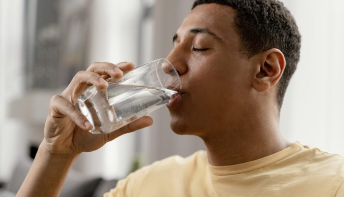 portrait-man-home-drinking-glass-water